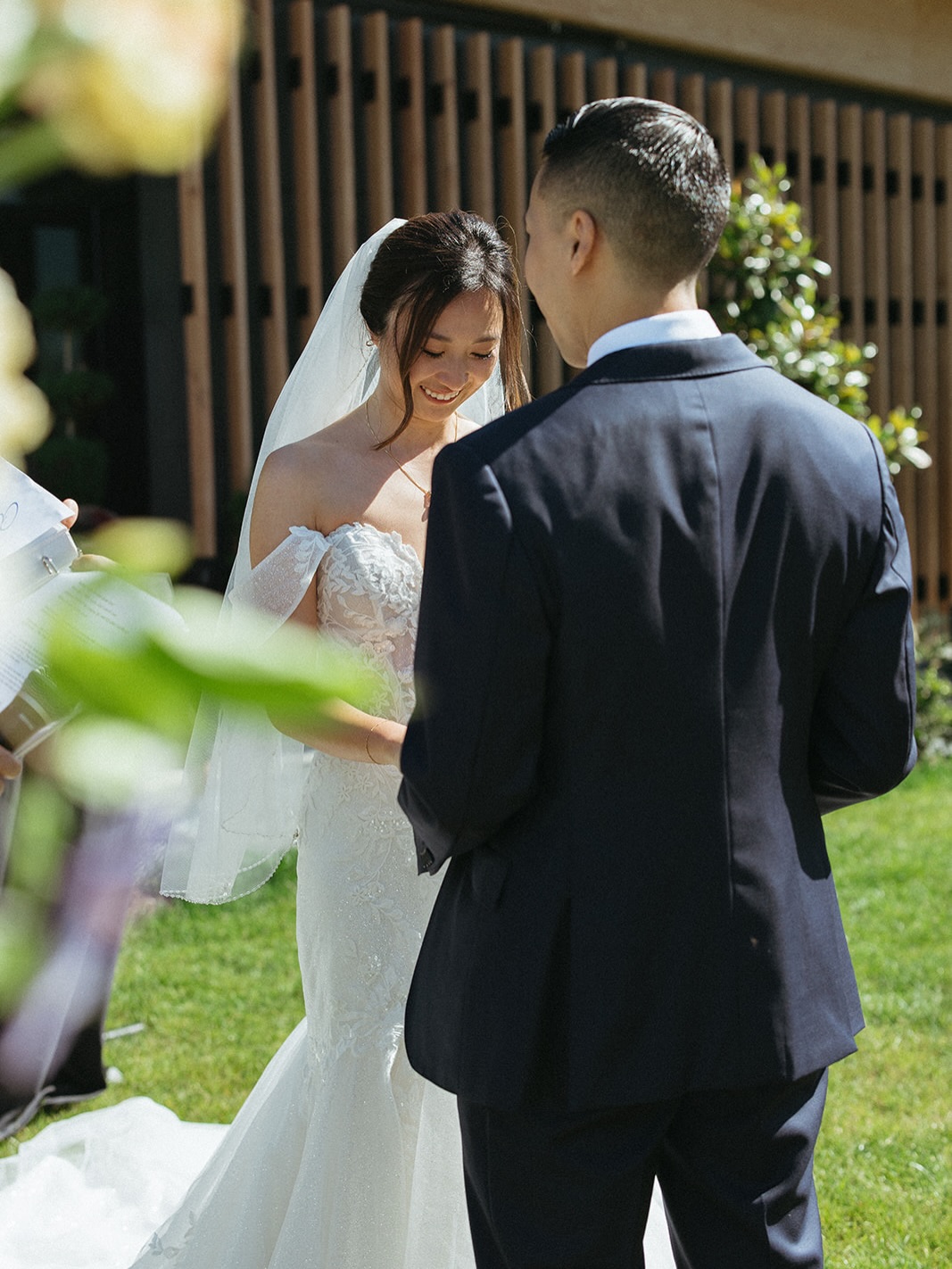 Bride and groom exchanging vows at the outdoor ceremony