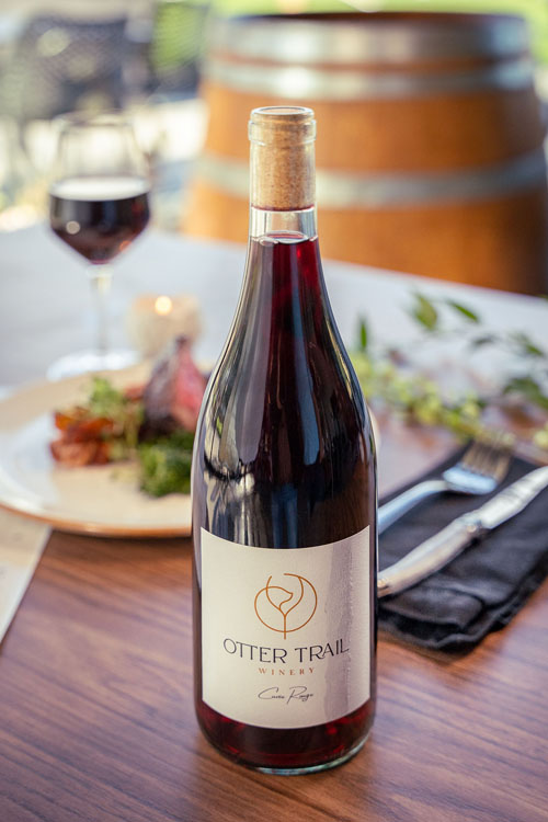 Otter Trail Cuvée Rouge bottle with plated dinner