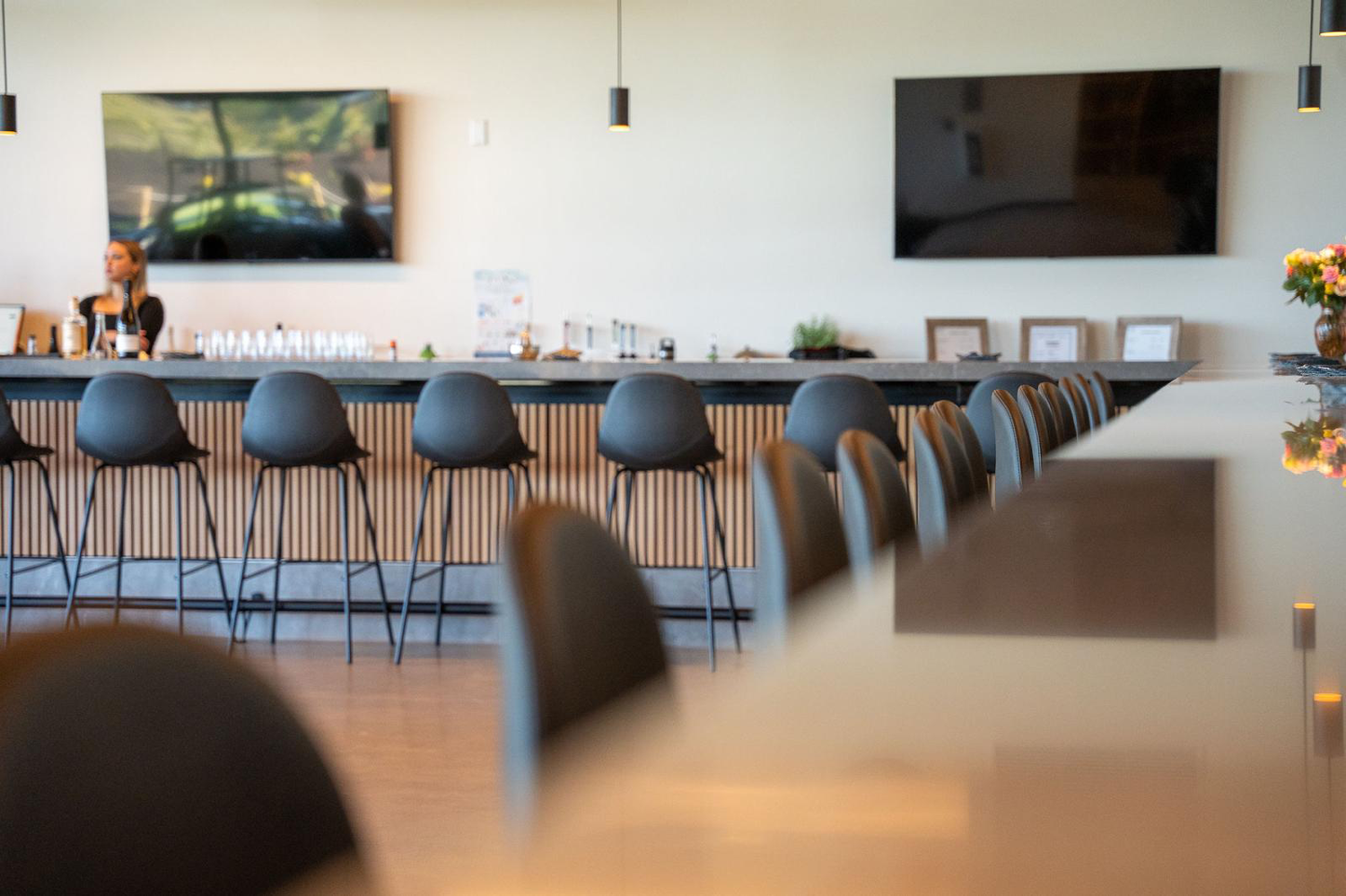 Venue bar with seating and mounted TVs