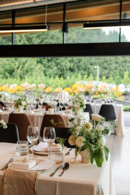 Reception tables set with florals and vineyard views