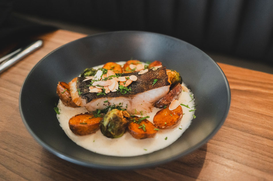 Pan-seared fish with carrots, brussels sprouts, and almonds