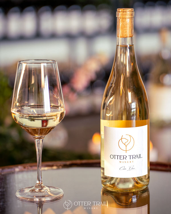 Otter Trail Cuvée Blanc bottle with glass of white wine