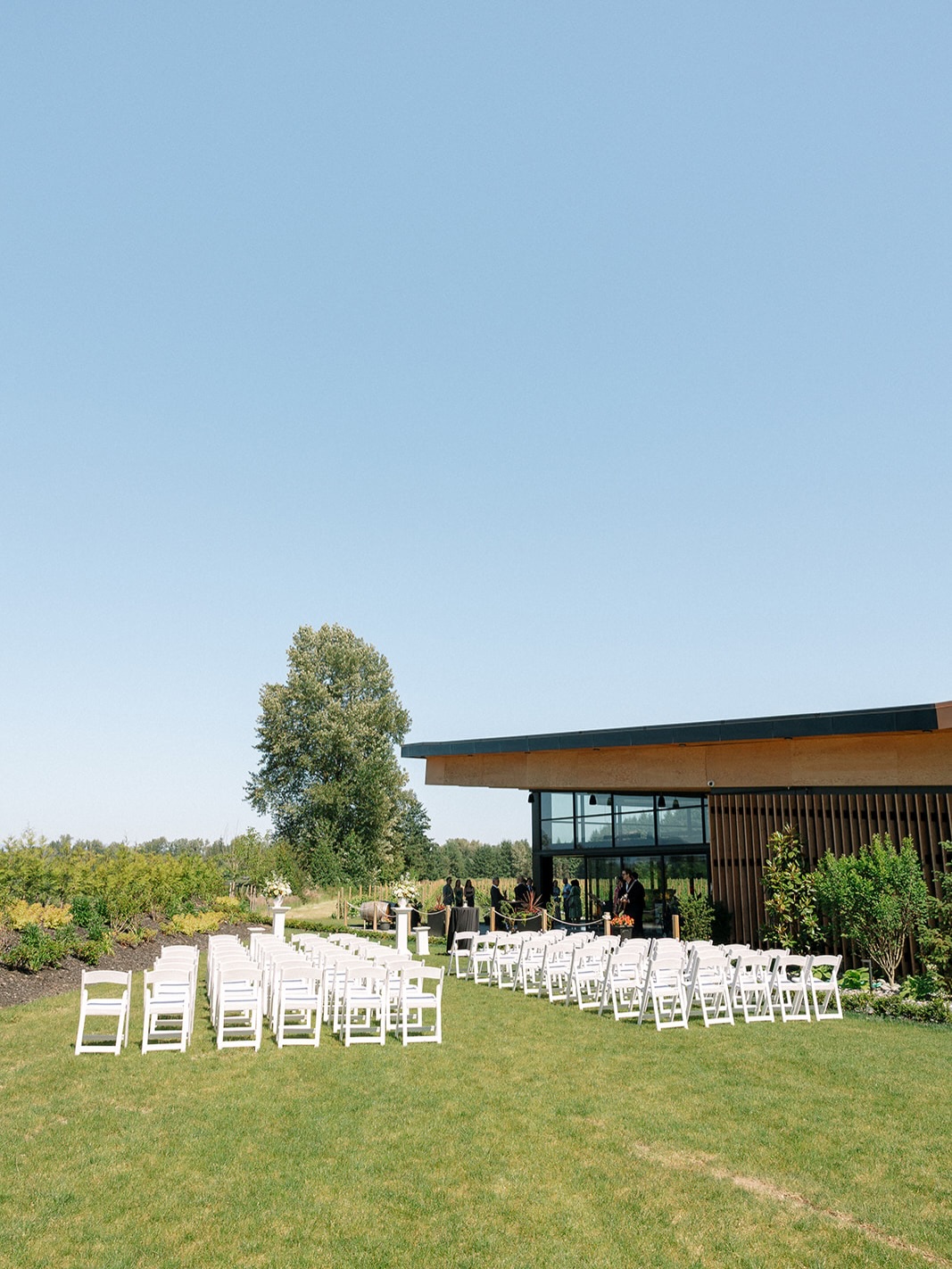 Outdoor ceremony chairs arranged on the lawn beside the venue
